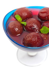 Plum Compote Isolated on a white background. Selective focus.