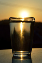 Refraction of the Sun in a glass of water during the sunset