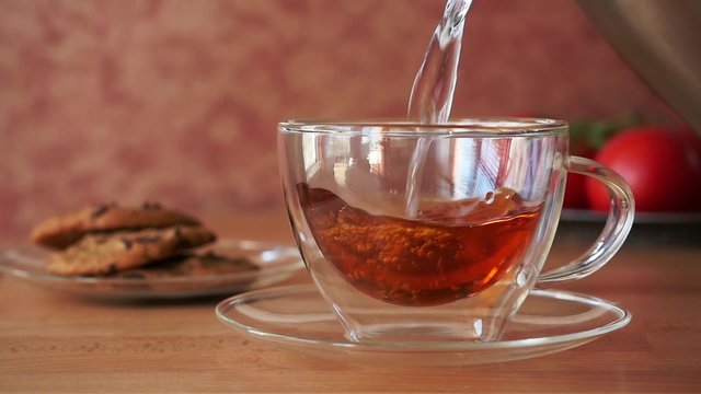 Tea Pouring into Glass Cup, Slow Motion.