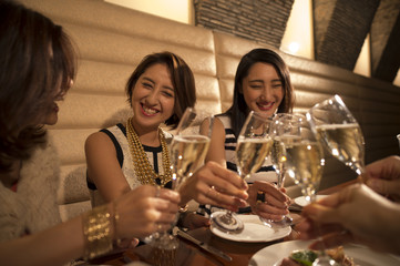 Women are toast with champagne in a luxurious restaurant