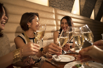 Women are toast with champagne in a luxurious restaurant