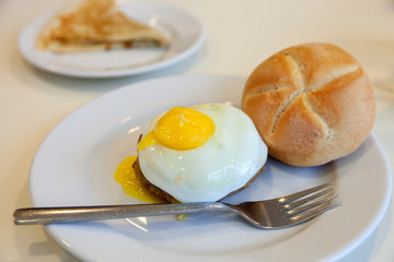 A hamburg steak with fried egg on white plate
