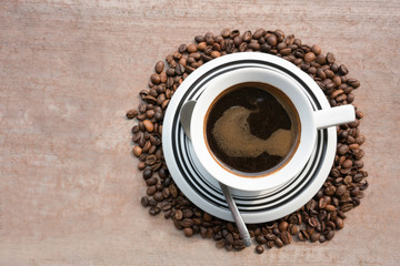 Dark Coffee in the middle of coffee beans