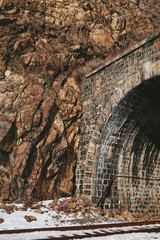 railway tunnel in the rock in the winter on a clear day
