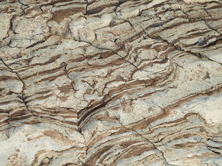 Brown waves on the surface of the stone.