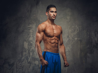 Obraz na płótnie Canvas Shirtless muscular man posing.
