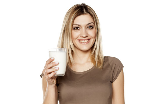 happy young woman hold a glass of milk