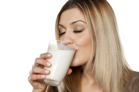 happy young woman drinking milk from a glass
