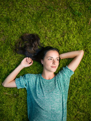 lies on green moss relaxing