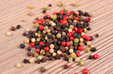 Heap of fresh colored pepper on wooden background