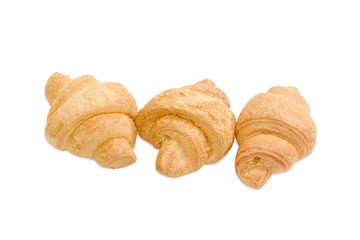Three small croissant on a light background
