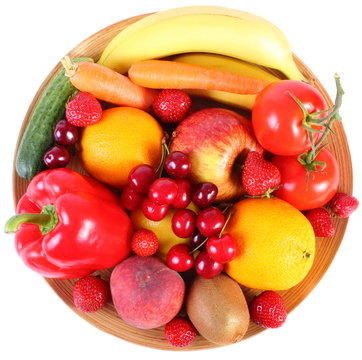 Fresh Fruits And Vegetables On Wooden Plate