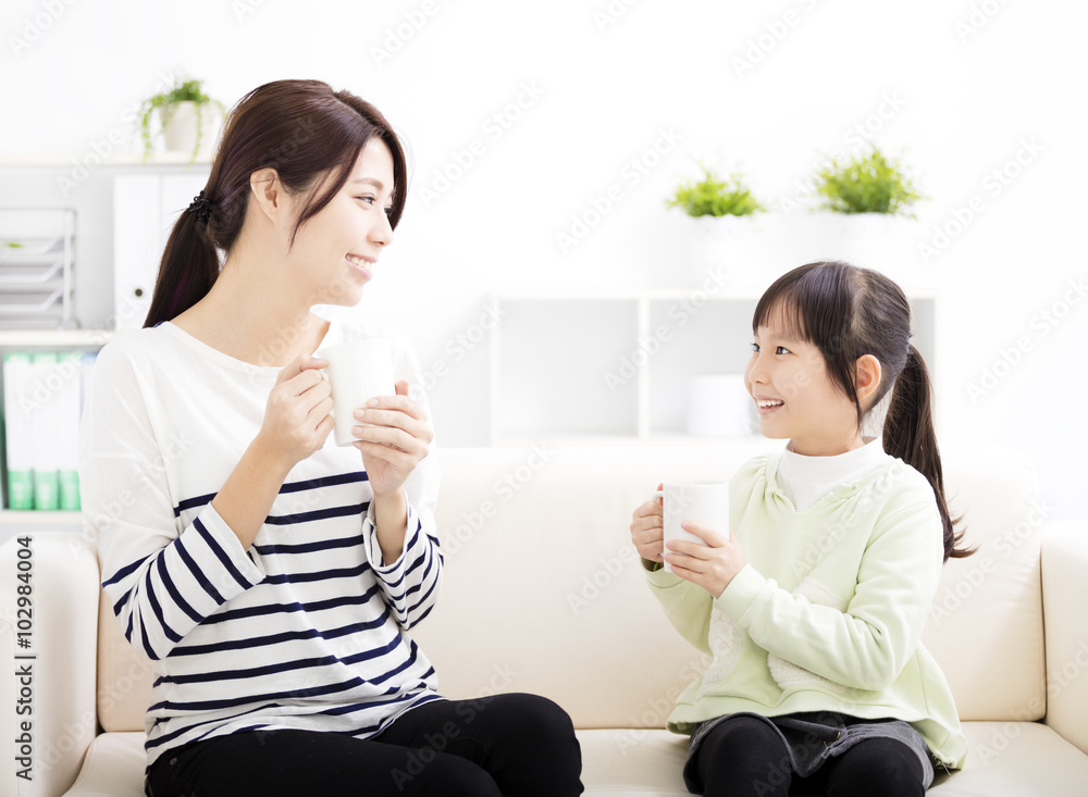 Canvas Prints smiling mother and daughter on the sofa