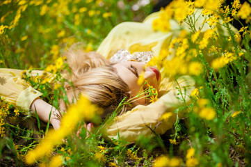 Attractive woman in yellow flowers