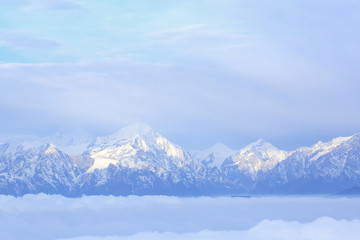 Fototapeta na wymiar beautiful fog among frozen mountain summits landscape