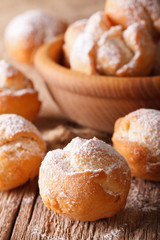 Festive Italian donuts Castagnole close up in a bowl. vertical

