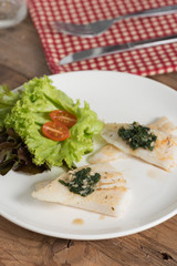 Clean food, Fish fillet with basil and garlic sauce on white pla