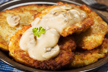 Homemade potato pancakes served with mushroom sauce and mushroom
