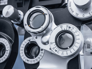 Photograph of detail of a phoropter in an eye doctor's office. The dials on the phoropter are seen...