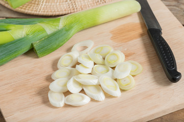 Fresh leeks and sliced on a wooden board.