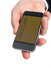 Photograph of a man's hand holding out a smart phone. The phone has gold credit card displayed on the screen. The image illustrates how the smartphone has become the new wallet.