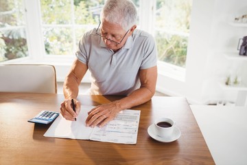 Worried senior man with tax documents