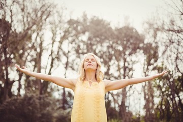 Happy woman with arms raised