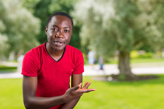 Closeup portrait of easy going clueless young man, student arms out asking what's the problem