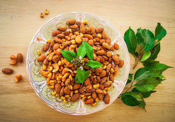 Salted fresh corn, almond cashew on plate with herbs and mint, A