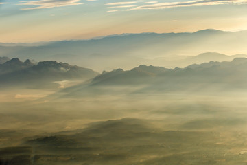 Layer of mountains and mist at sunset time