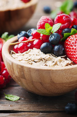 Oats withmix of berry on the wooden table