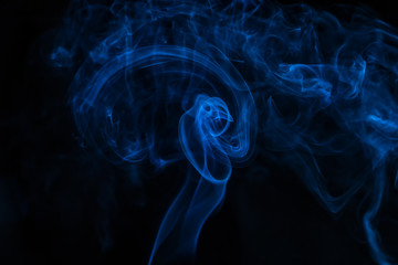 Blue smoke on black background