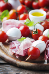 Fresh prosciutto with basil and mozzarella