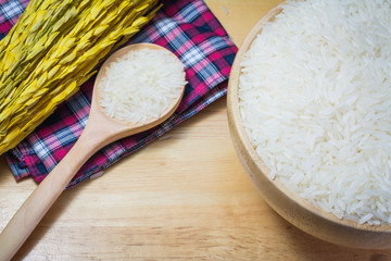 Rice in wooden bowl on Sack or wood table background