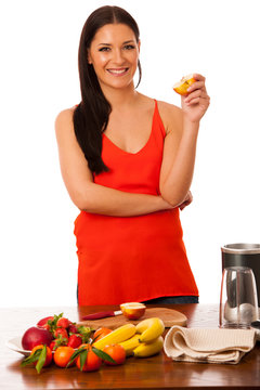 Woman holding half of apple in hand preparing healthy fruit smoo
