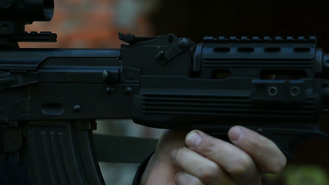 man aims from the weapon, the camera shows a closeup on the right