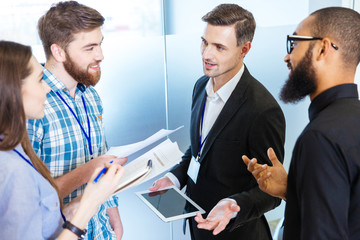 Young business people standing and talking with chief executive