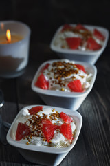 Delicious breakfast of useful products . Bee pollen with cottage cheese , sour cream and grapefruit .