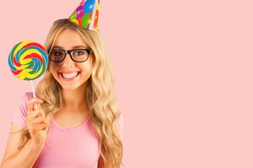 Composite image of portrait of a hipster with a party hat 