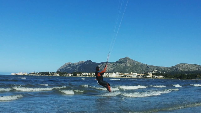 Kite Surfer gliding over blue waters