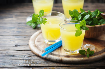 Yellow fresh cocktail with mint and ice