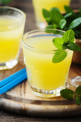 Yellow fresh cocktail with mint and ice