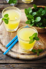 Yellow fresh cocktail with mint and ice