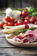 Antipasto with ham and green asparagus