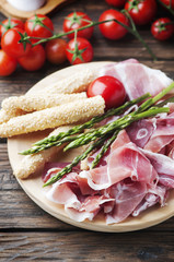 Antipasto with ham and green asparagus