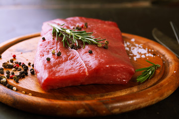 Raw beef steak with spices, garlic and rosemary