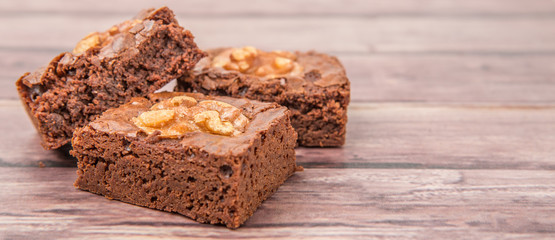 Chocolate walnut brownies over wooden background