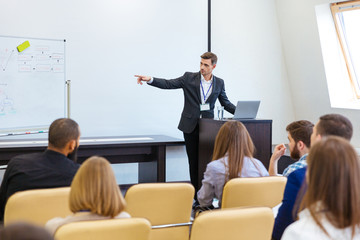 Speaker giving presentation at business conference