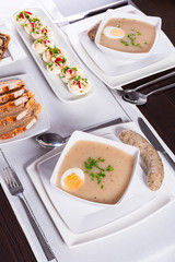 Easter traditional breakfast with white borsch soup, eggs and sausages