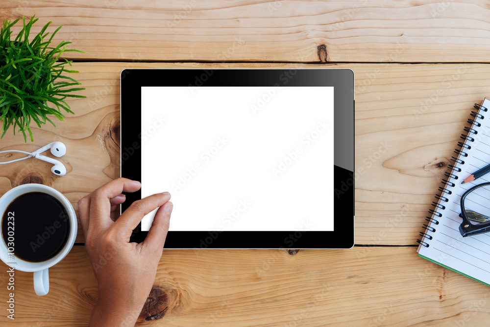 Poster hand using mockup tablet on wood desk white display with clippin